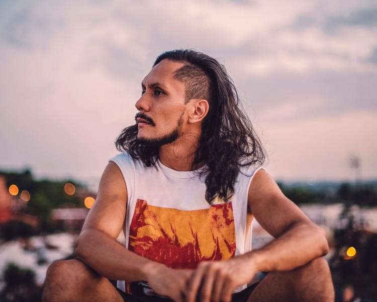 portrait-of-hispanic-male-with-long-hair-he-is-sitting-in-the-roof-with-bokeh-in-the-background-t20-glvwyd.jpg