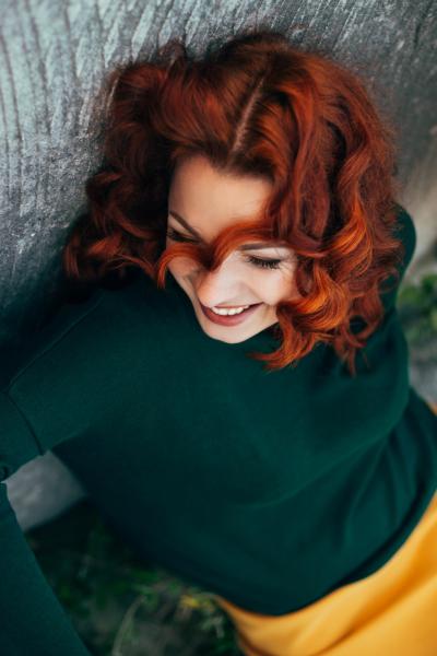 young-beautiful-red-haired-plus-size-woman-in-green-sweater-laughing-t20-a99xwm.jpg